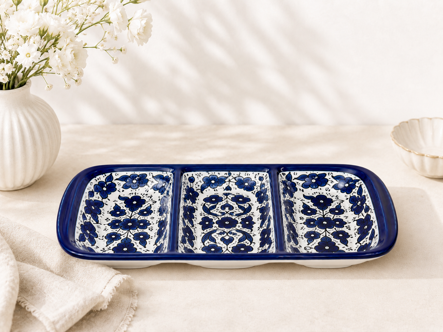 handcrafted 3-compartment serving dish features an elegant cobalt blue floral pattern.