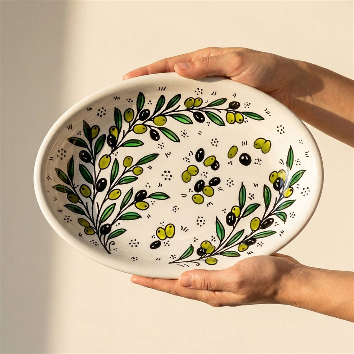 Ceramic Oval Serving Dish 11.81 Inch in Olive Green, held in hands to show scale