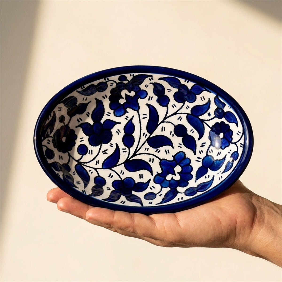 Ceramic Oval Serving Dish 6.69 Inch in Indigo, held in hands to show scale