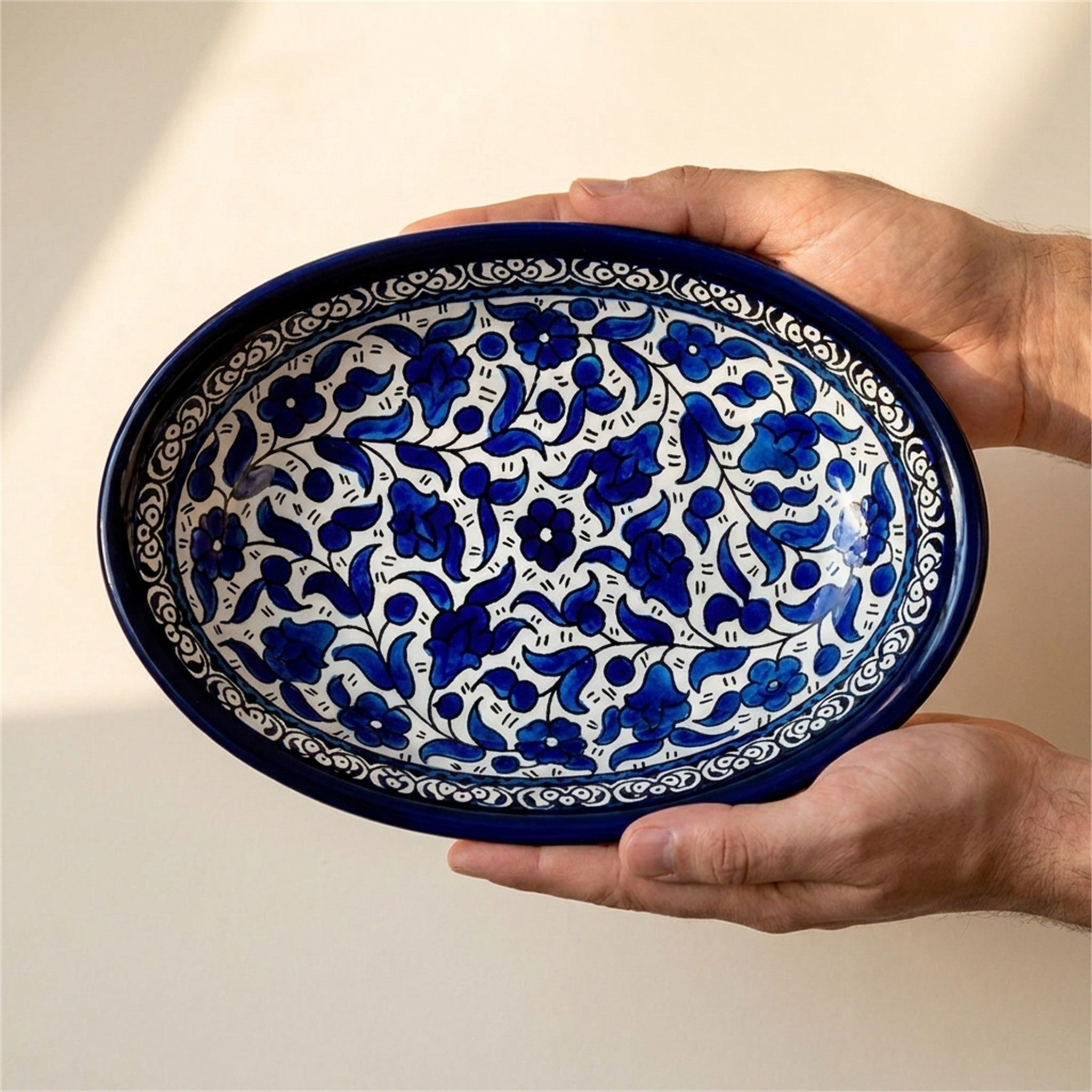 Ceramic Oval Serving Dish 9.06 Inch in Indigo, held in hands to show scale