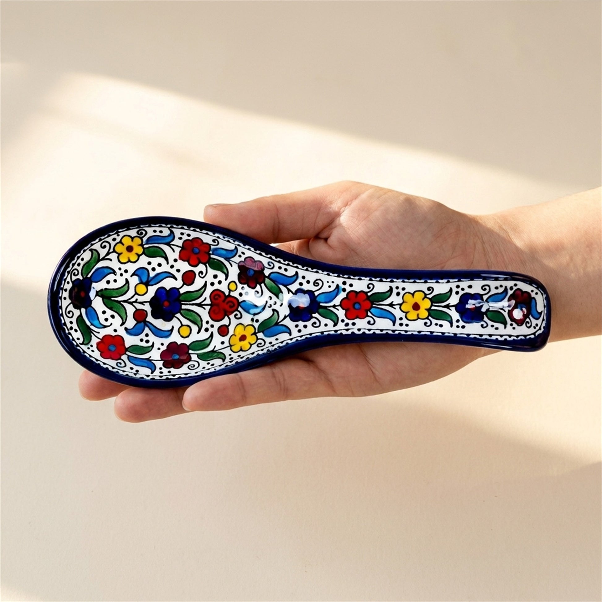 Ceramic Spoon Rest 9.84 Inch in Floral, held in hands to show scale