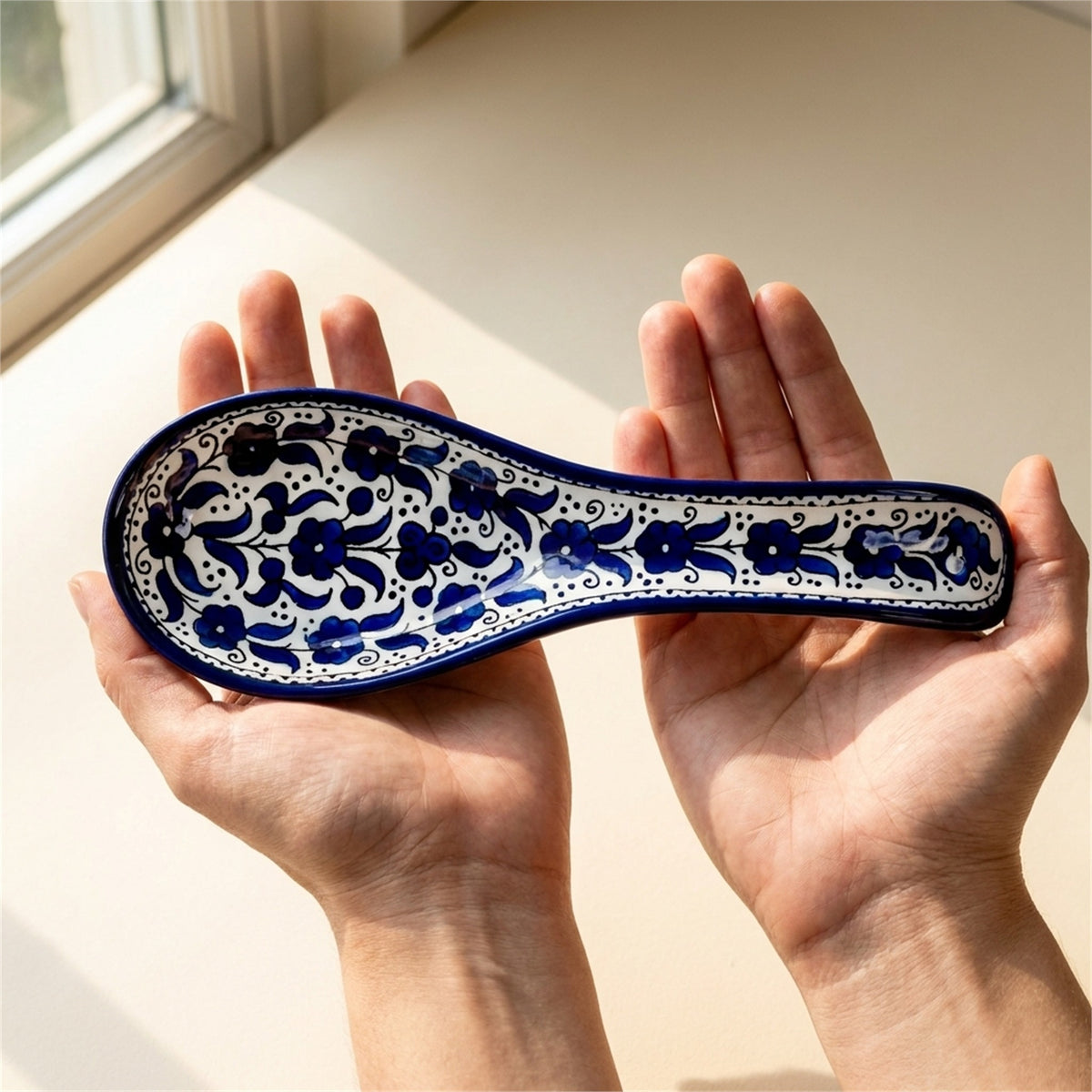 Ceramic Spoon Rest 9.84 Inch in Indigo, held in hands to show scale