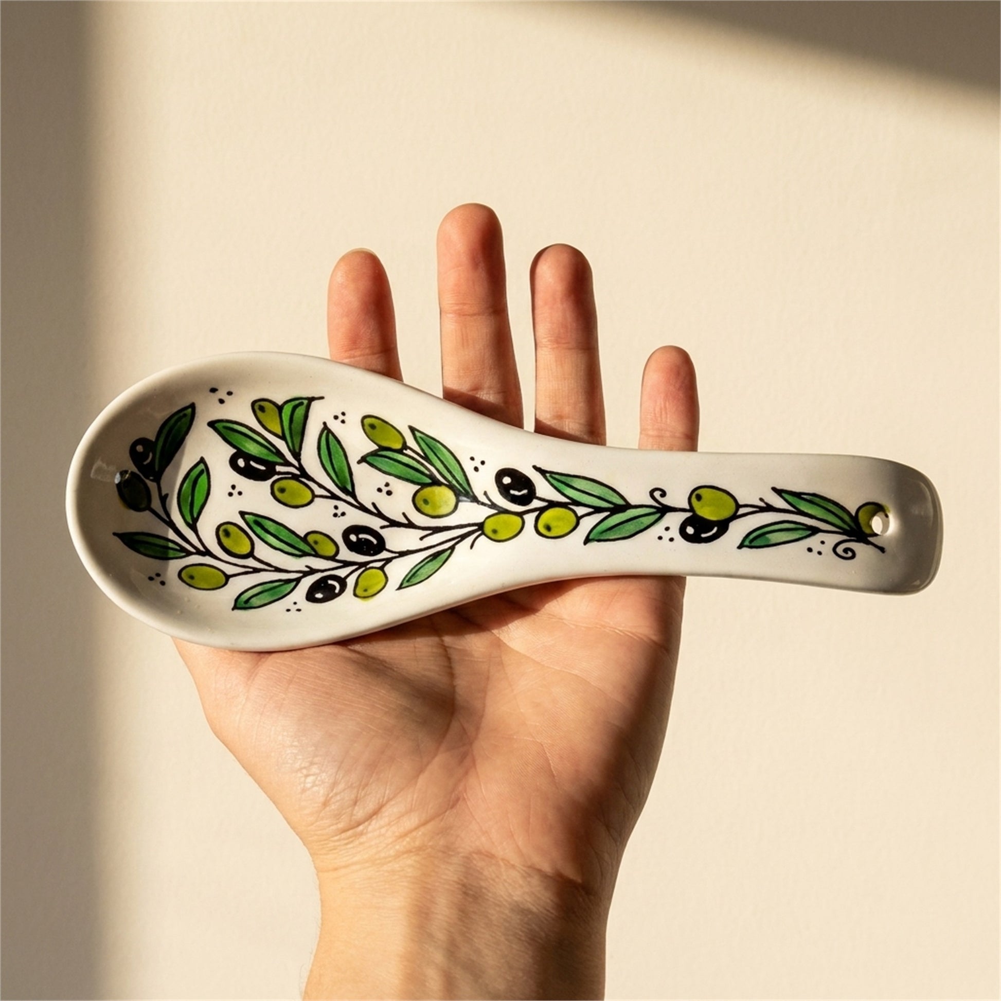 Ceramic Spoon Rest 9.84 Inch in Olive Green, held in hands to show scale