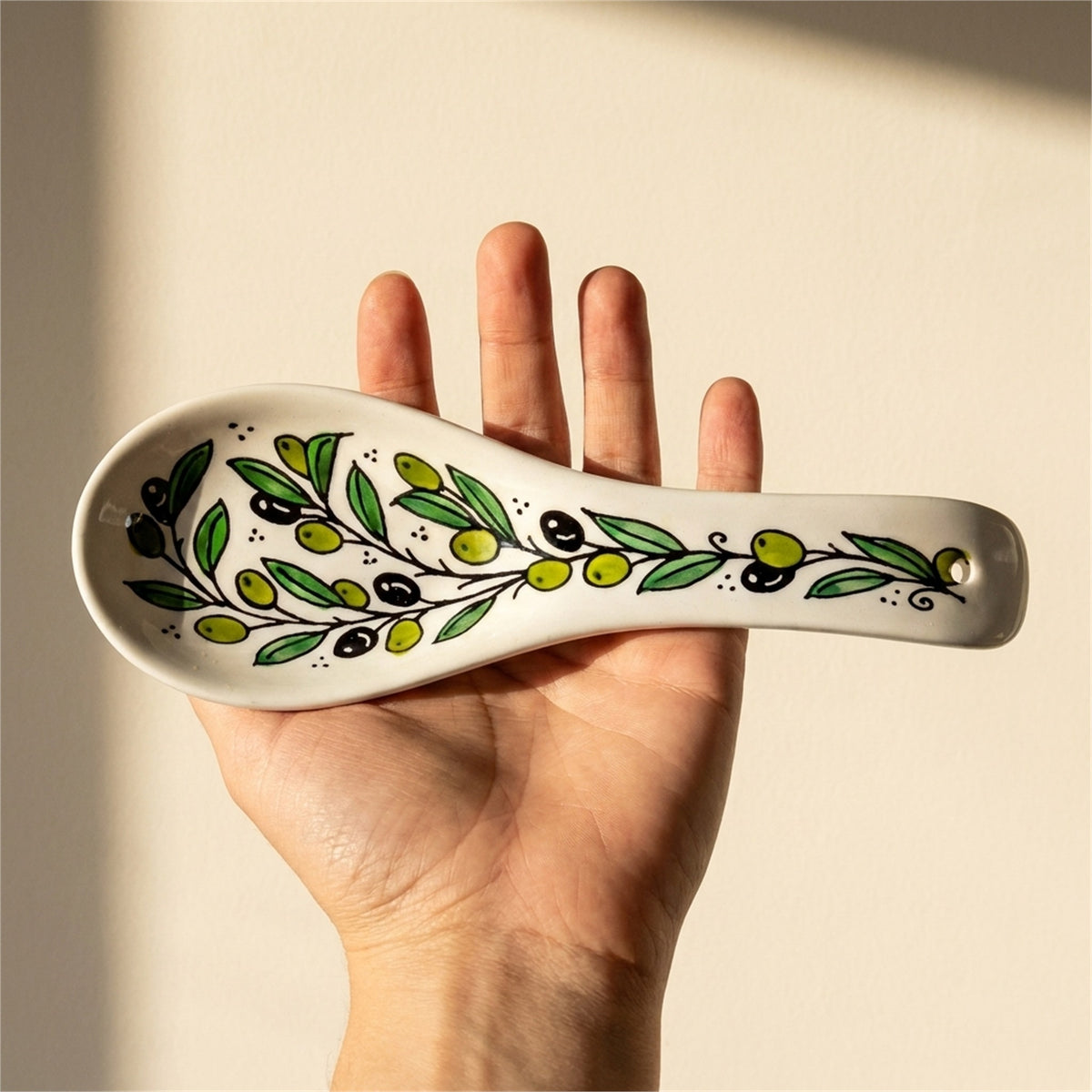 Ceramic Spoon Rest 9.84 Inch in Olive Green, held in hands to show scale
