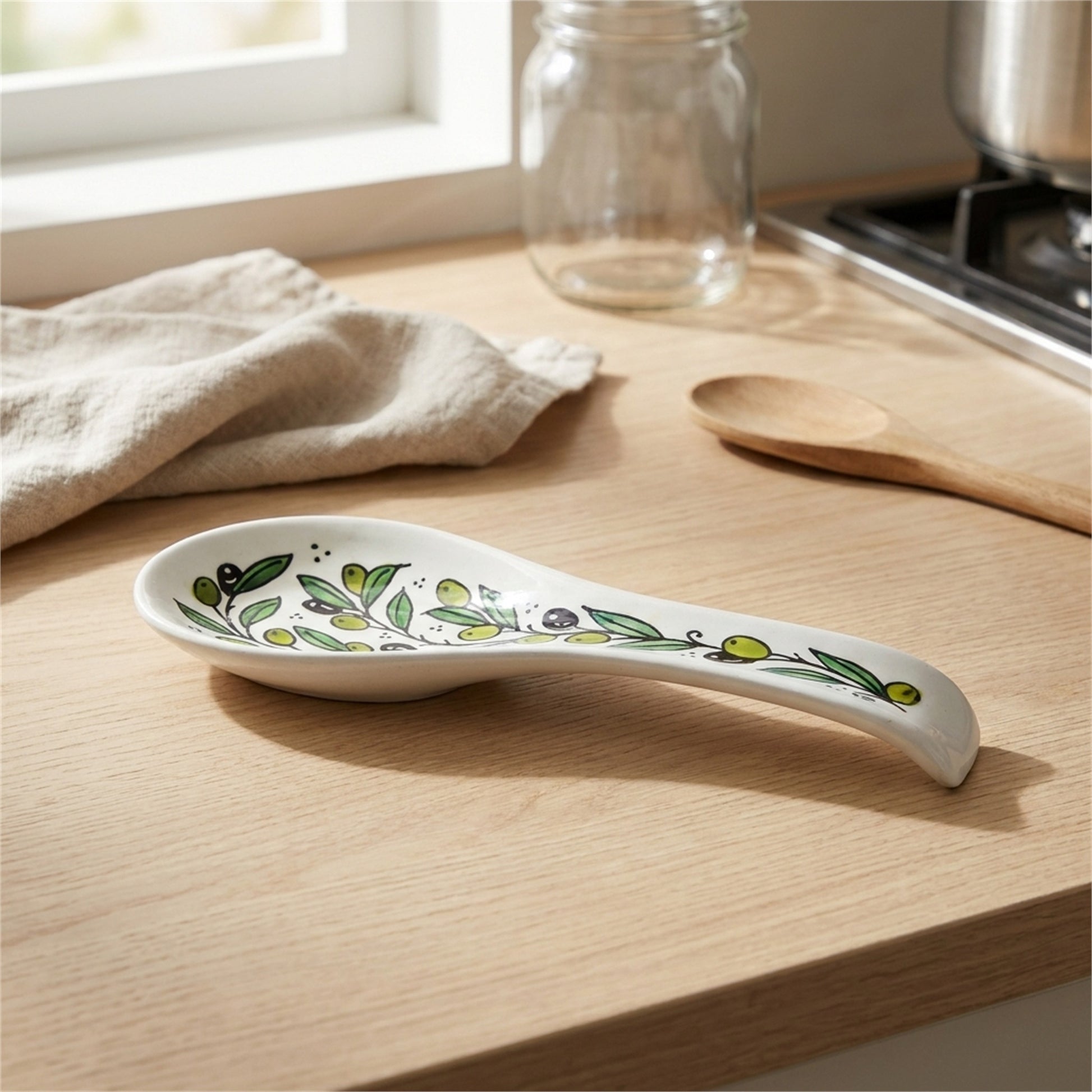 Ceramic Spoon Rest 9.84 Inch in Olive Green, styled on a set table