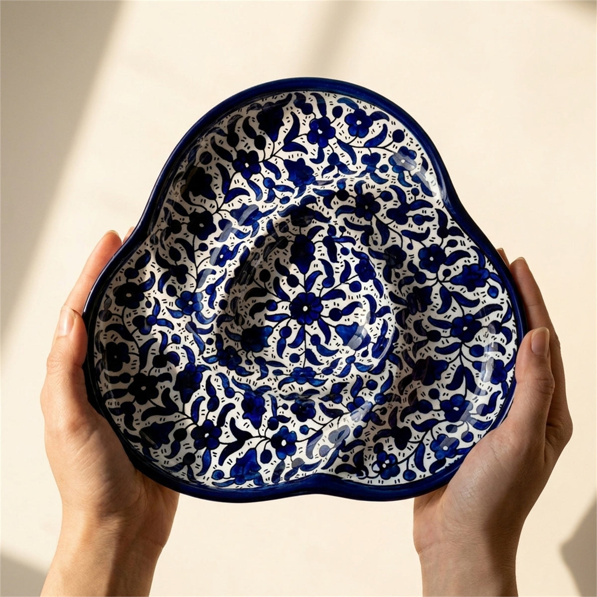 Ceramic Trefoil Dish 9.84 Inch in Indigo, held in hands to show scale